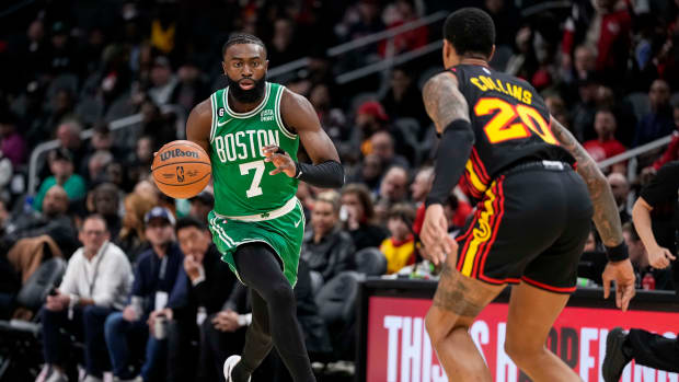 Hawks forward John Collins defends Celtics guard Jaylen Brown.